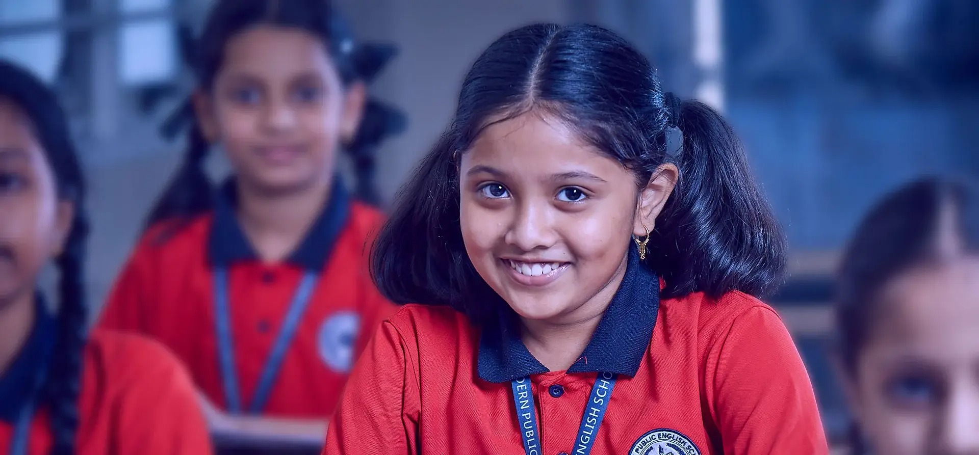 Bright, airy preschool classroom with colorful learning materials on white walls and natural wooden furniture