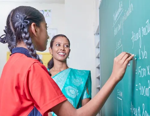 Children engaged in creative art activity at a well-lit preschool table with colorful supplies