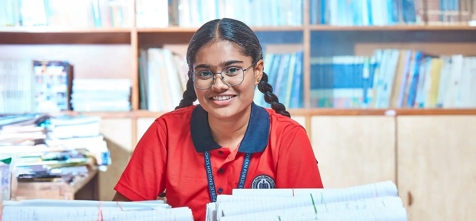 Friendly preschool teacher reading a picture book to attentive young children in a cozy corner
