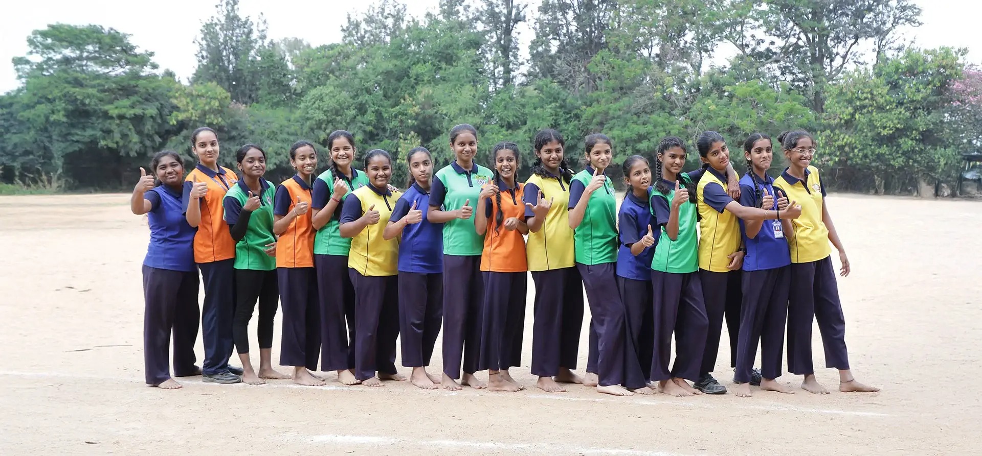 Friendly preschool teacher reading a picture book to attentive young children in a cozy corner