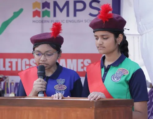 Friendly preschool teacher reading a picture book to attentive young children in a cozy corner